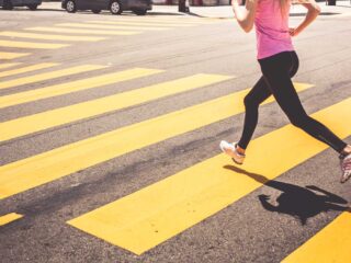 Blonde Woman Running Over The Pedestrian Crossing